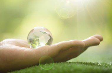 Close up of Green Planet in Your Hands. Save Earth. Environment Concept. 